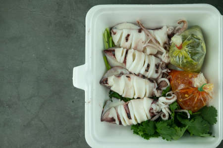Squid egg steamed and vegetable in box with spicy chilli and lemon sauce. Thai food hot and spicy.