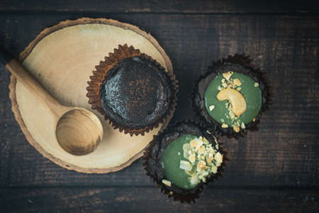 Chocolate brownie tart with various of topping on wood tableの写真素材