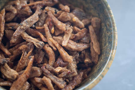Close up of fried crispy tiny fish in bowlの写真素材