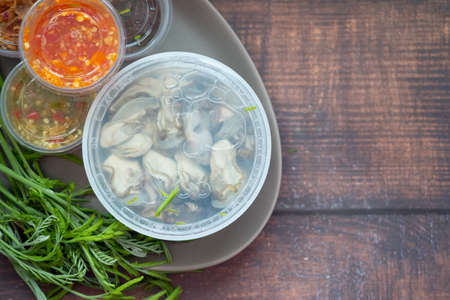 Yummy food is Oysters with herbs, Kathina leaves and chili source. Oyster spicy salad favorite Thai sea food menu.の写真素材