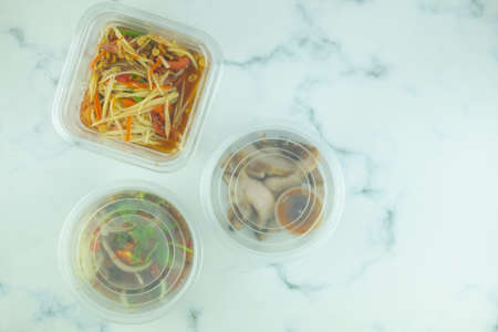Somtum papaya salad spicy set Thai style, grill pork and grilled pork salad in box