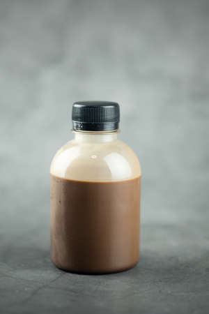 Chocolate milk in bottle on a black backgroundの写真素材