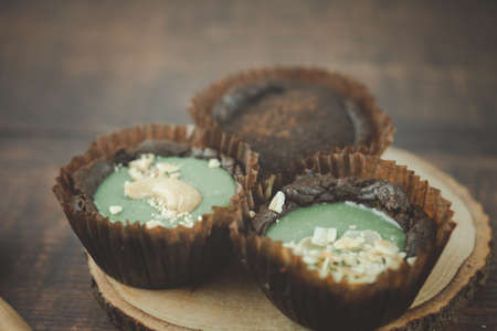 Chocolate brownie tart with various of topping on wood tableの写真素材