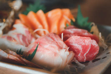 Fresh raw salmon fish sashimi is sliced in Japanese cuisine. Assorted fresh sashimi and Japanese food concept. Selective focusの写真素材