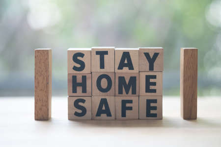 Arranging wood block stacking with text Stay at home stay safe, protect for your health.の写真素材