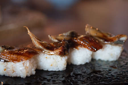 Japanese Sushi - Unagi Nigiri Sushi (Eel Sushi) on black tray. Fresh delicious Japanese sushi.の写真素材