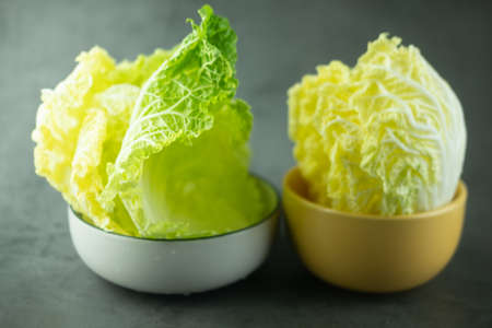 Heap fresh of green leaf iceberg lettuce for wrap Thai food in bowl on black backgroundの写真素材