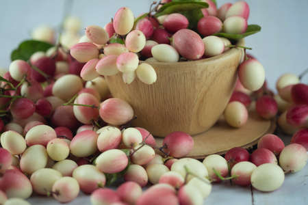 Karanda plum or Koromcha fruits in wooden cup