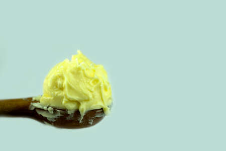 Soft butter on wooden spoon. Soft butter on wooden spoon. Represent the cooking ingredient related. Close upの写真素材