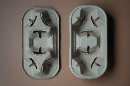 Front and back of container for hot drinks on brown background. Concept of recyclable materials