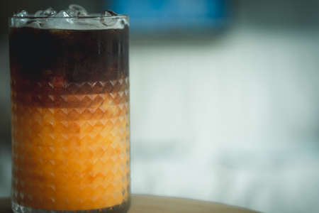 A glass of espresso shot mixed with orange juice. refreshment drinkの写真素材