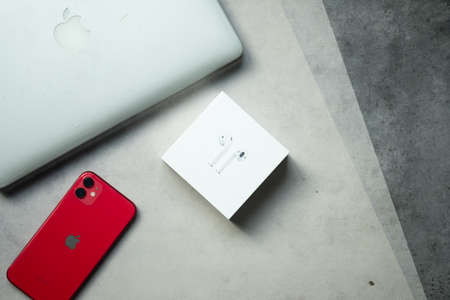 Samut Prakan, Thailand - June 14, 2020 : Apple iPhone 11 PRODUCT RED with Airpods and computer Mac Pro all product from Apple company. Concept of cumulative product from Apple companyのeditorial素材