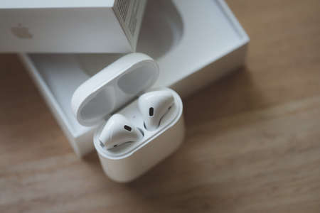 Samut Prakan, Thailand - June 18, 2020 : Apple AirPods wireless headphone with charging box. Use...