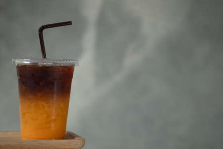 Cold brew coffee mixed with fresh orange juice. That has two layer of combination between orange juice and black coffeeの写真素材