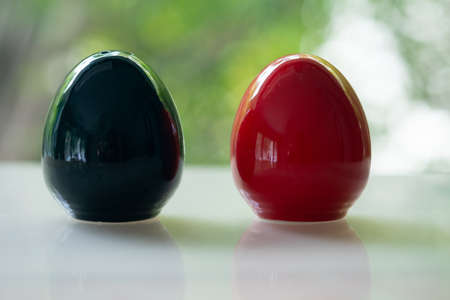 Black and red of egg shape ceramic shakers for salt and pepperの写真素材
