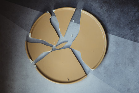 Close up one broken empty yellow ceramic dish.の写真素材