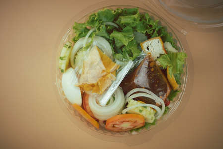 Islamic salad vegetable, boiled egg, crispy fried dumpling and many fresh vegetable topping dressing sweet bean sauce in box. Halal foodの写真素材