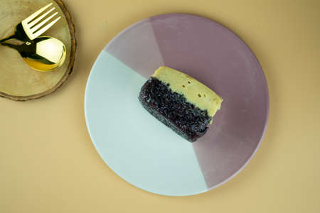 Sweet egg custard over sweet black sticky rice on plate. Thai Dessert.