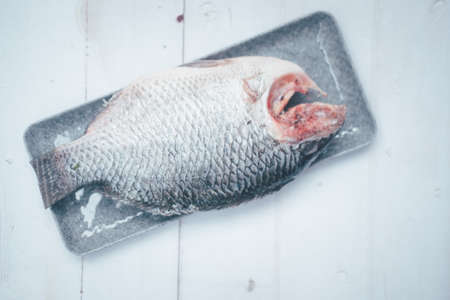 Close up raw Nile tilapia fish on tray ready to fried. Thai style food