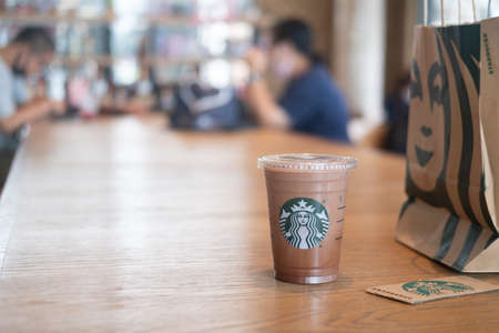 Samut Prakan, Thailand - July 11, 2020 : Glass of Starbuck coffee iced mocha served on wood table in...