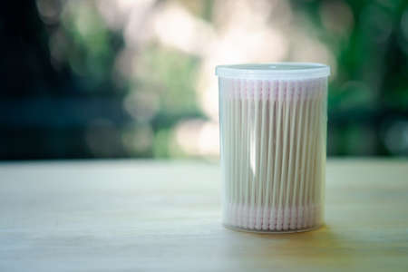 Pink cosmetic cotton buds in box. Soft cotton buds for skin care or cleaning. Symbol of hygiene, beauty care and bathroom itemの写真素材