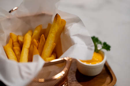 French fries in basket with mustard sauce. Selective focus