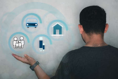 Close up hand with related icon graphic interface showing life such as family, home, car, education,...