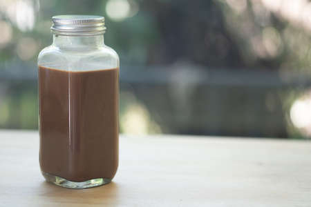 Coffee mocha in glass bottle on wood tableの写真素材