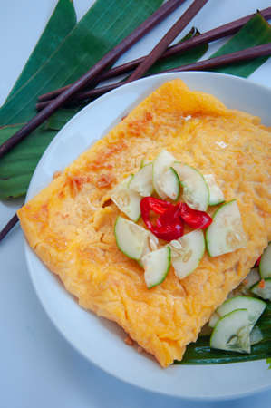 Vietnamese styled stuffed crispy egg crepe, local dessert made from many kinds of vegetable, shrimp, tofu, peanut and wrapped with egg pan like pancakeの写真素材