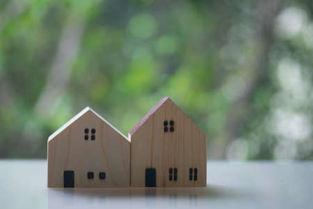 Two of lovely small model house with nature green bokeh sunlight abstract background. New property investment concept.の写真素材