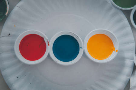 Top view of three water colour of paint on mini paper dish. Concept of learning by doingの写真素材