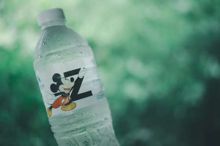 Bangkok, Thailand - August 6, 2020 : Bottle of Singha Drinking Water new collection "Mickey Mouse Collection" on nature backgroundのeditorial素材