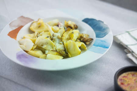 Grilled squid on ceramic dish served with Thai spicy seafood dipping sauce.の写真素材