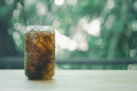 Fresh and cold soft drink in glass on wood table arrange on nature blur nature background with copy space.の写真素材