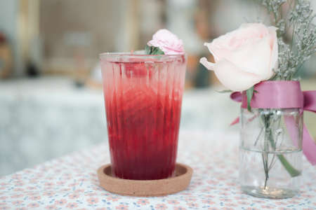 Fresh iced tea roselle in glass on table in coffee shop. Cold summer drink.の写真素材