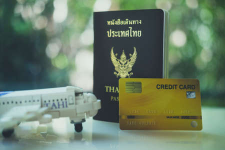 Toy plane and Thai passport with credit card for travel. Concept of travel