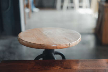 Close up of wood and metal backless bar stool. Loft design ideas for coffee shop