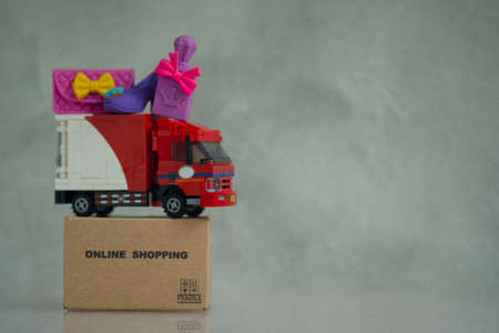 Miniature cargo car for sent order from woman customer. Concept of online shoppingの写真素材