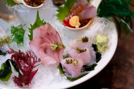 Top grade japanese sashimi or raw fish on ice. Japanese food. Fish sashimi set in promotion packageの写真素材