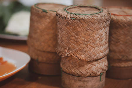 Thai sticky rice in a bamboo wooden old style box showing the Thai way of lifeの写真素材