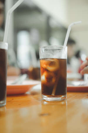Close up of soft drink in glass with ice on table at Thai local restaurantsの写真素材