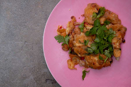 Homemade mixed vegetable omelette simple but delicious in pink plate. Thai people knows it well