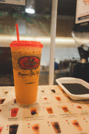 Bangkok, Thailand - September 23, 2020 : Iced Thai milk tea from the famous of Thai tea branding Cha Tra Mue, popular Thai tea brand and specialty tea productsのeditorial素材