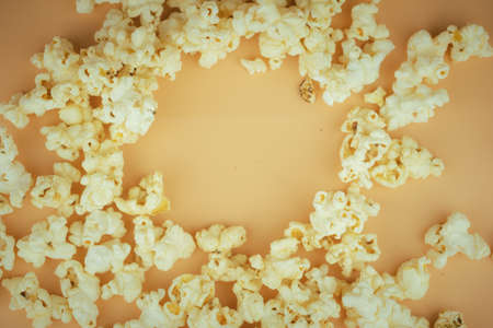 Salted popcorn on yellow background. Top view with copy space. Flat layの写真素材