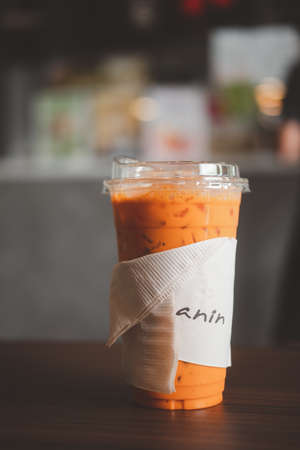 Bangkok, Thailand - October 10, 2020 : Iced Thai milk tea in container that can be decomposed...
