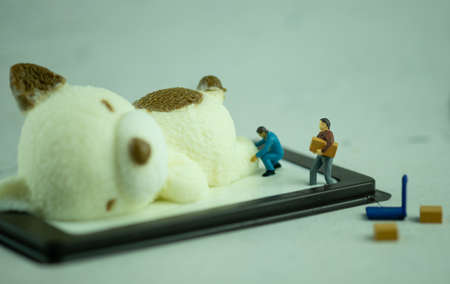 Miniature workers unloading coconut milk jelly in bear shape. Cooking and decoration concept.の写真素材