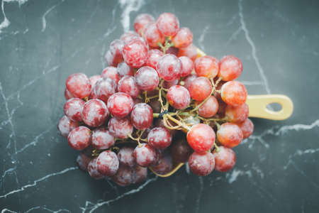 A bunch of red grapes on a black backgroundの写真素材
