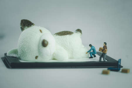 Miniature people move coconut milk jelly in bear shape. Cooking and decoration concept.の写真素材