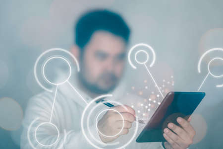 Young man in white hoodie use digital tablet and interface screen. Concept of technology