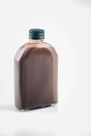 A retro style bottle of fresh chocolate milk shake on a white background